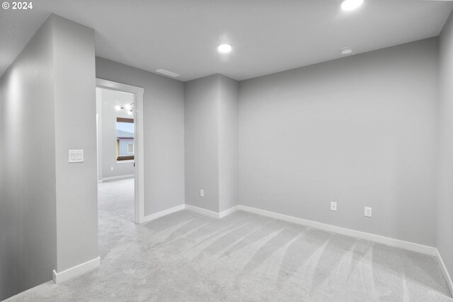 unfurnished room with light colored carpet