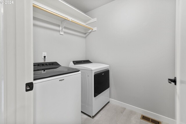 washroom with independent washer and dryer