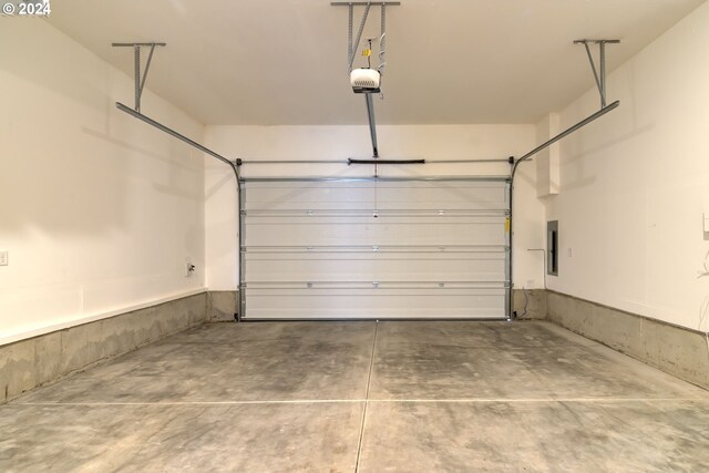 garage featuring electric panel and a garage door opener