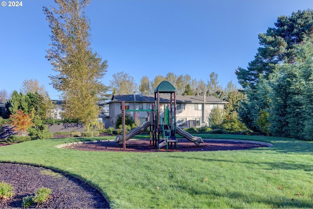 view of jungle gym featuring a lawn