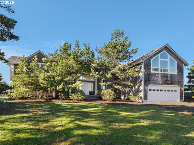 view of front of home with a front yard and a garage