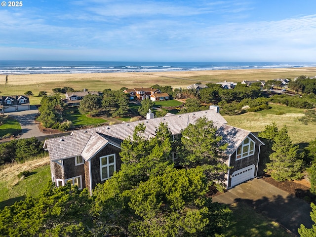 birds eye view of property featuring a beach view and a water view