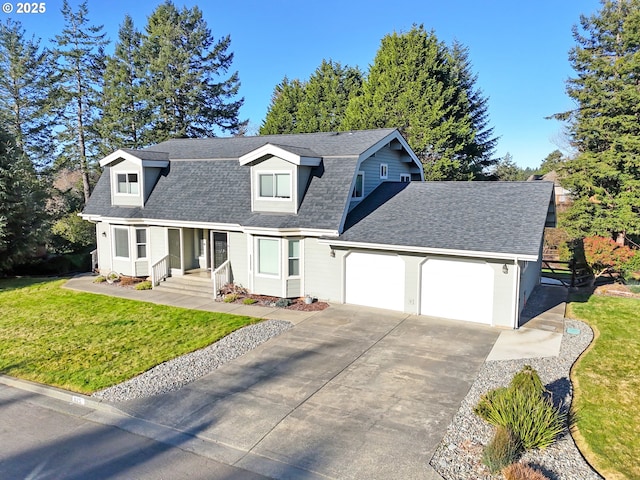 cape cod house with a front yard and a garage