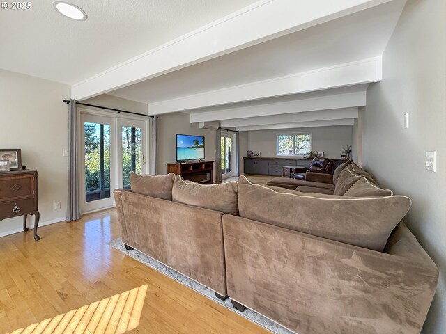 living room with light hardwood / wood-style flooring and beamed ceiling