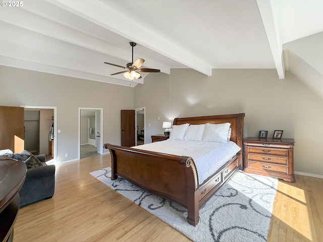 bedroom featuring ceiling fan, light hardwood / wood-style flooring, and lofted ceiling with beams