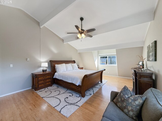 bedroom featuring light wood-type flooring, vaulted ceiling with beams, and ceiling fan