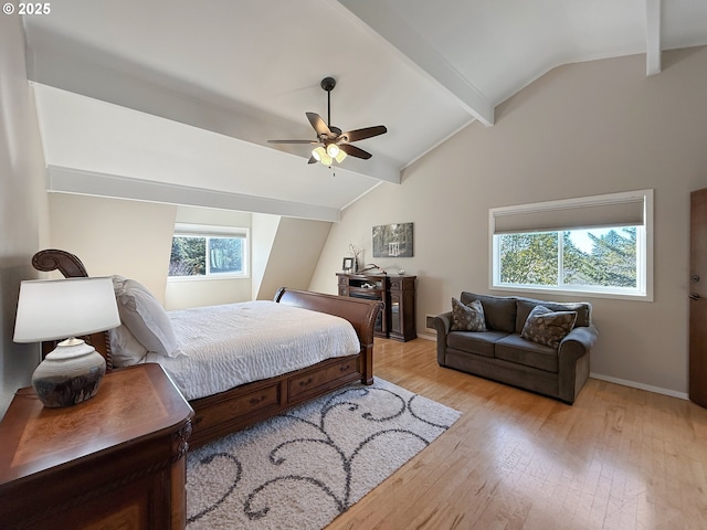 bedroom with light wood-type flooring, ceiling fan, and lofted ceiling with beams