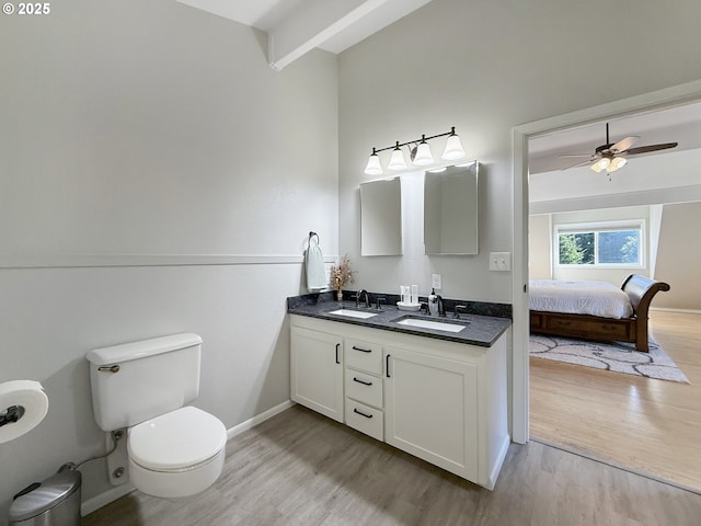 bathroom featuring hardwood / wood-style flooring, beamed ceiling, vanity, and ceiling fan