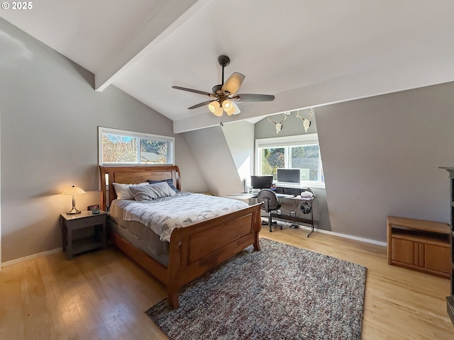 bedroom featuring light hardwood / wood-style floors, ceiling fan, and lofted ceiling with beams