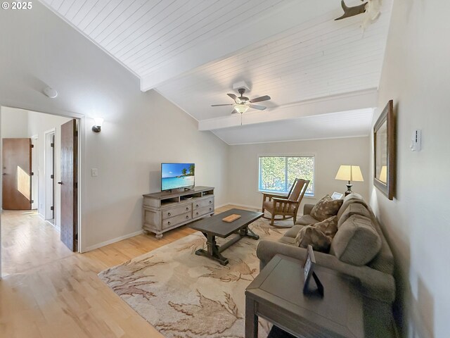 living room with ceiling fan, lofted ceiling with beams, and light wood-type flooring