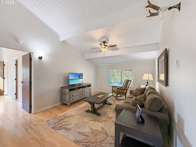 living room with light wood-type flooring, vaulted ceiling with beams, and ceiling fan