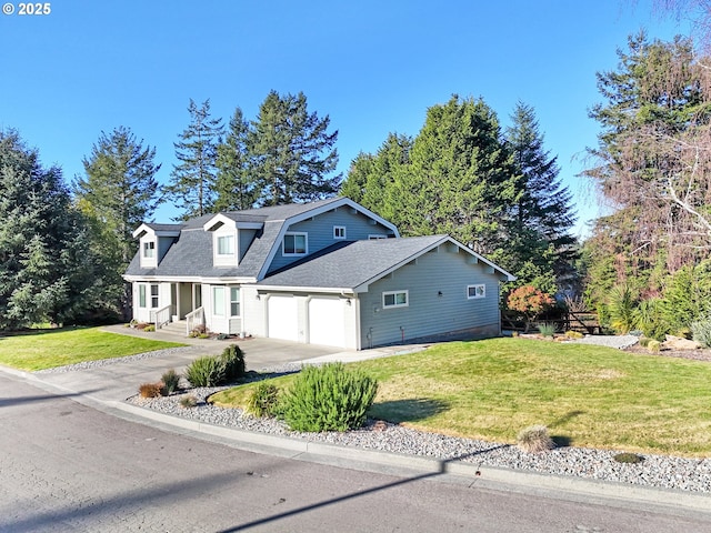 view of front of house featuring a front yard and a garage