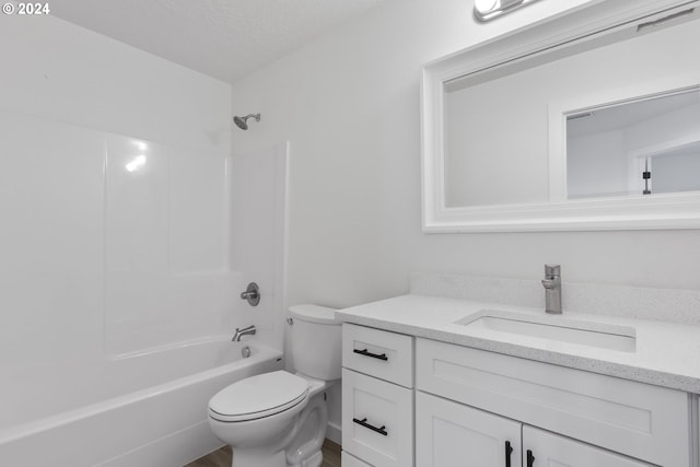 full bathroom featuring a textured ceiling, vanity, toilet, and shower / bath combination