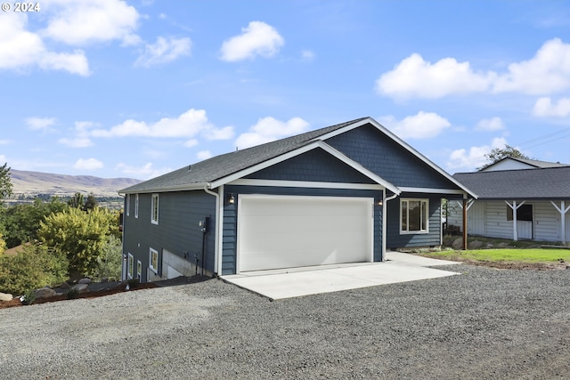 view of front facade with a mountain view and a garage