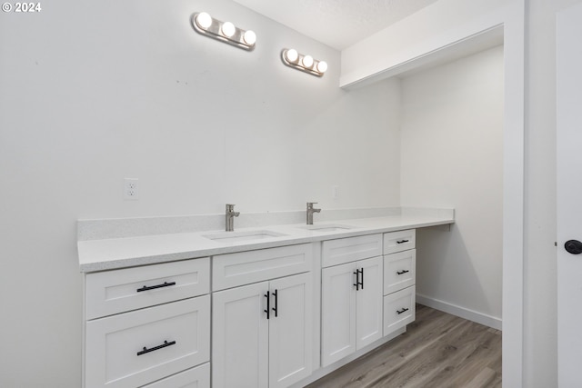 bathroom featuring a textured ceiling, hardwood / wood-style flooring, and vanity