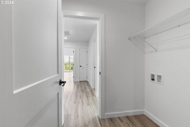 laundry room featuring washer hookup and light wood-type flooring