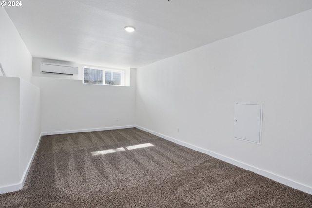 unfurnished room with dark carpet and a wall mounted air conditioner