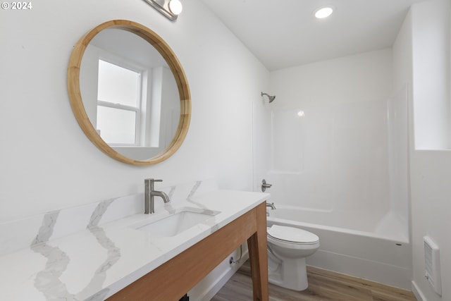 full bathroom with vanity, shower / bath combination, hardwood / wood-style floors, and toilet