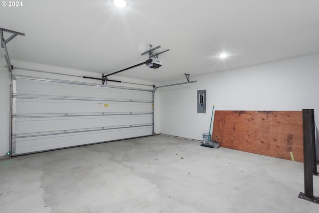 garage with a garage door opener and electric panel