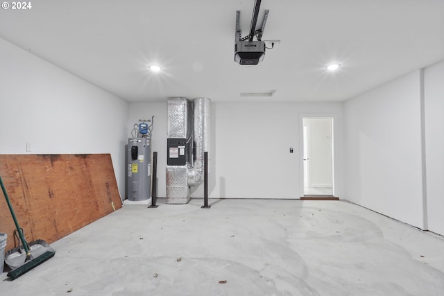 garage featuring water heater, a garage door opener, and heating unit