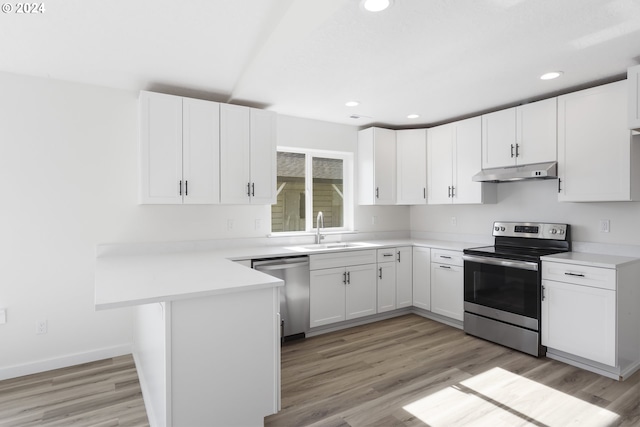 kitchen with white cabinets, appliances with stainless steel finishes, sink, and light hardwood / wood-style flooring