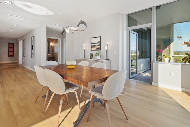 dining space with light hardwood / wood-style flooring