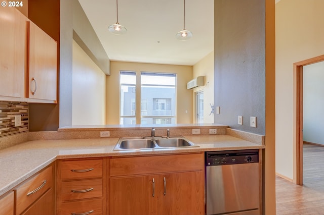 kitchen with pendant lighting, an AC wall unit, sink, stainless steel dishwasher, and tasteful backsplash