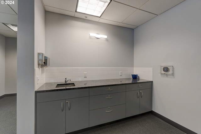 bathroom featuring a drop ceiling and sink