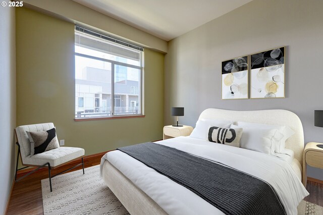 1125 NW 9th Ave Unit 524, Portland, OR 97209 - bedroom featuring wood finished floors and baseboards