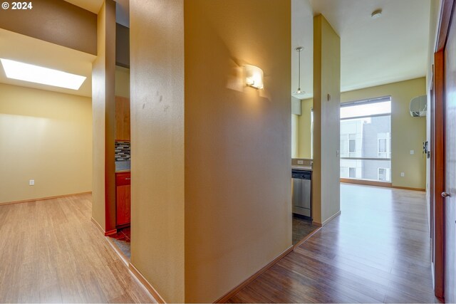 1125 NW 9th Ave Unit 524, Portland, OR 97209 - hall with a skylight, wood finished floors, and baseboards