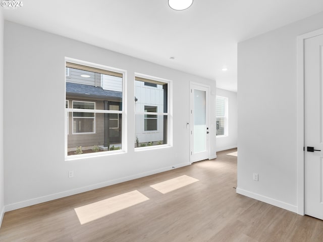 unfurnished room with light hardwood / wood-style flooring