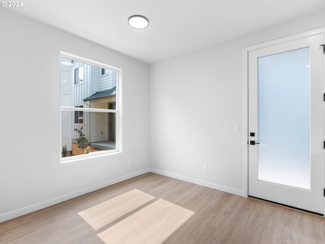 spare room with light wood-type flooring