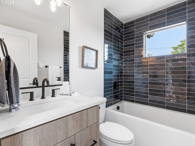 full bathroom with vanity, toilet, and tiled shower / bath