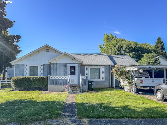 view of front of property with a front lawn and a carport