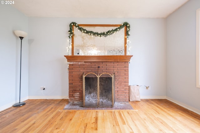 unfurnished living room featuring wood-type flooring and a fireplace