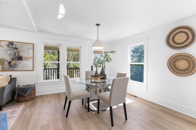 dining area featuring light hardwood / wood-style flooring and a healthy amount of sunlight