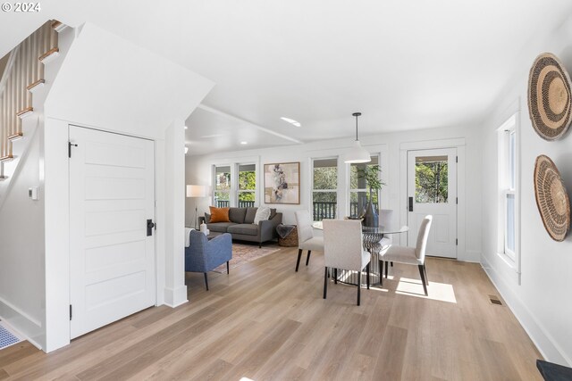 dining space with a wealth of natural light and light hardwood / wood-style floors