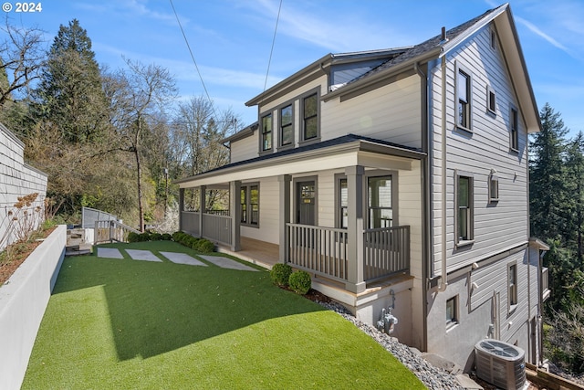 back of property featuring a lawn, central AC unit, and a porch