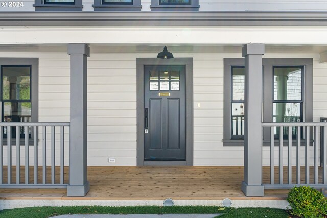 doorway to property featuring covered porch