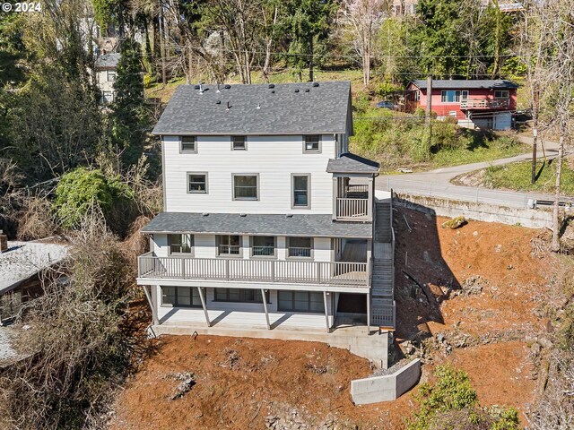 back of property with a balcony