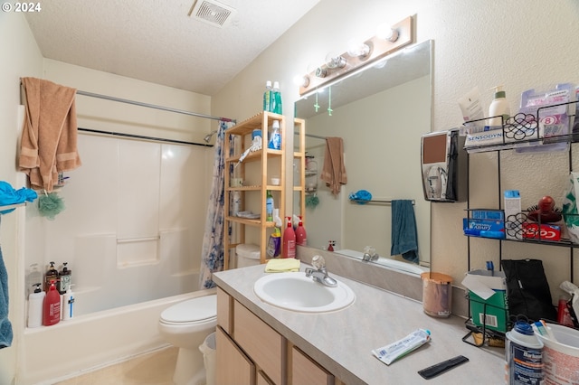 full bathroom featuring toilet, vanity, a textured ceiling, and shower / tub combo with curtain