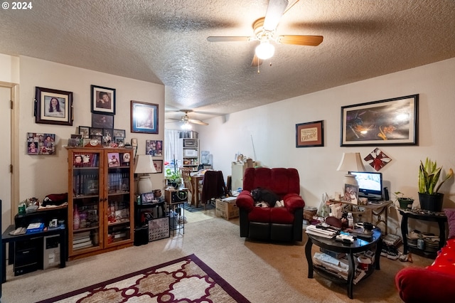 carpeted living room featuring ceiling fan and a textured ceiling