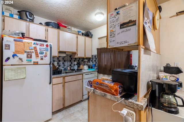 kitchen with light brown cabinets, white appliances, tasteful backsplash, and a textured ceiling