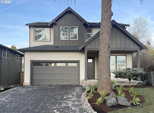 craftsman-style home featuring board and batten siding, decorative driveway, and a garage