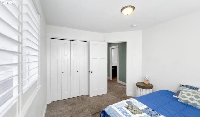 bedroom featuring dark carpet and a closet