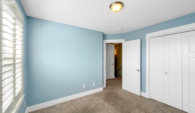 unfurnished bedroom featuring a closet and carpet flooring