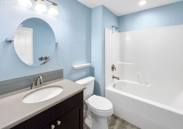 full bathroom featuring vanity, toilet, backsplash, shower / washtub combination, and hardwood / wood-style floors