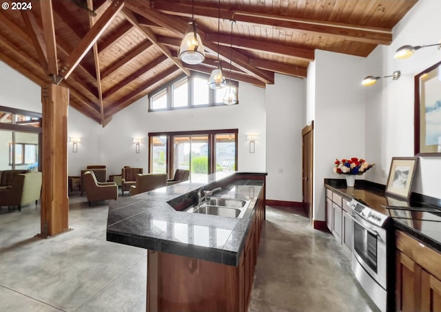 kitchen featuring pendant lighting, wood ceiling, sink, beam ceiling, and a center island with sink