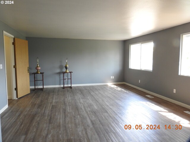 spare room featuring dark hardwood / wood-style flooring