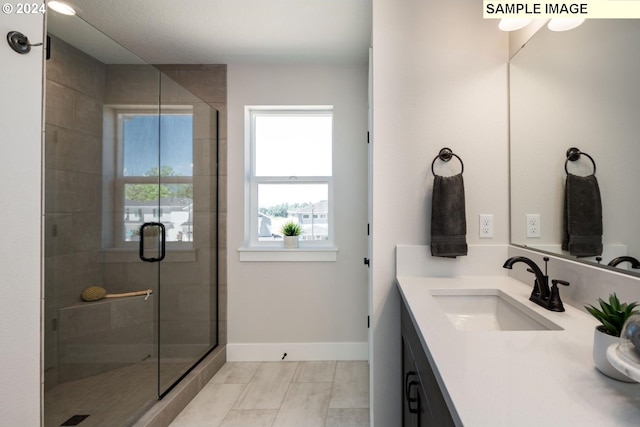 full bath with a shower stall, baseboards, and vanity